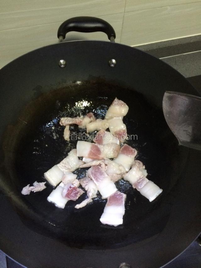 冷锅，加少许油把五花肉煎香。煎五花肉会逼出油分，如果油太多，可以铲一些油出来。（留着下次炒菜用）
