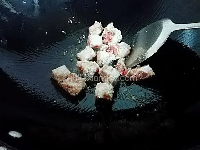 煮饭的同时先把料炒好，锅预热，放入花生油，油温热后把排骨放下去煎两面黄