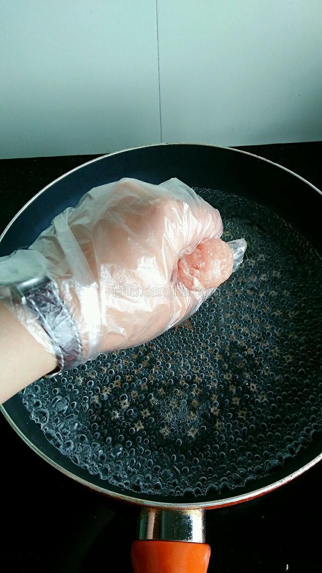 锅置火上烧开适量水，加入适量油，用手将肉末挤成丸子，用勺子刮到锅中。