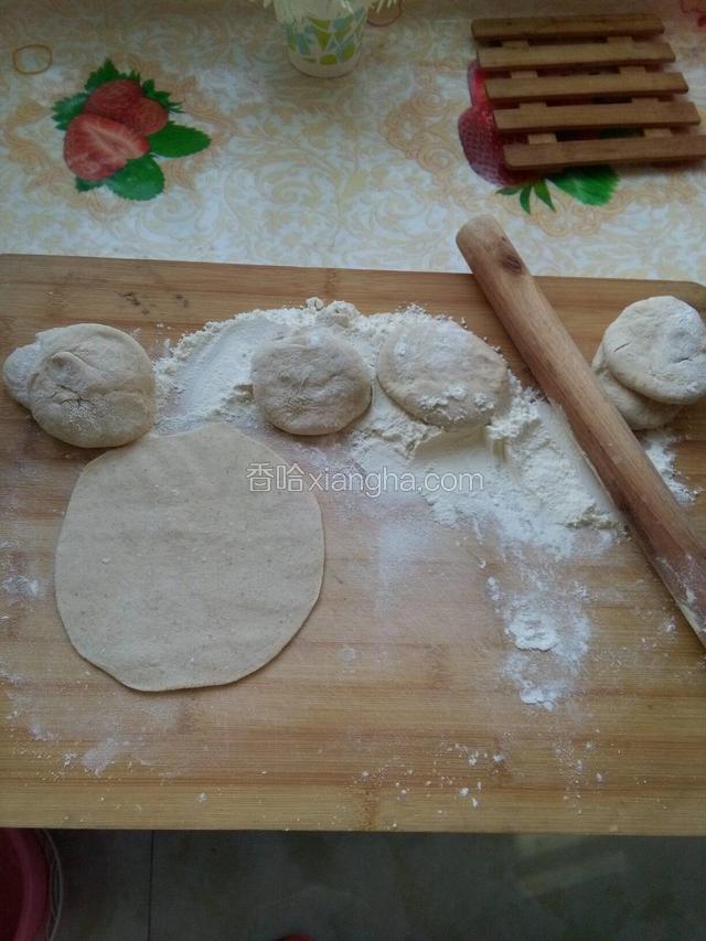 把发酵好的面分几次取出，揉一揉排出多余的空气，再把面分成差不多的小面团，擀面棍擀成面皮备用。