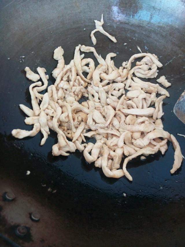 锅内倒油烧热，把鸡肉倒进炒，变色盛出备用