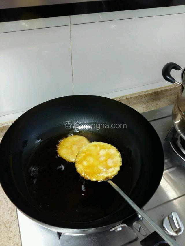 用勺子把虾糊舀的饼贴里在送进油锅里炸