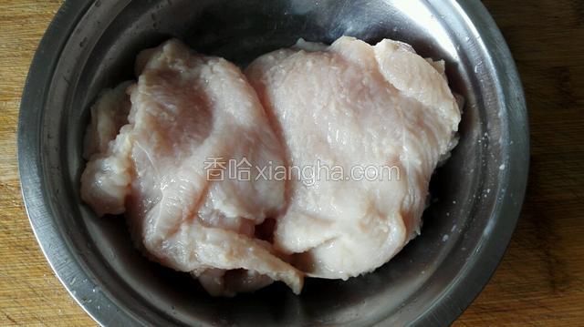 把鸡胸肉放进碗里倒入少许料酒揉搓几下。