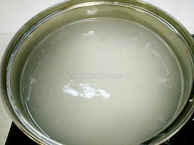锅里注入适量清水烧开，加入大米。