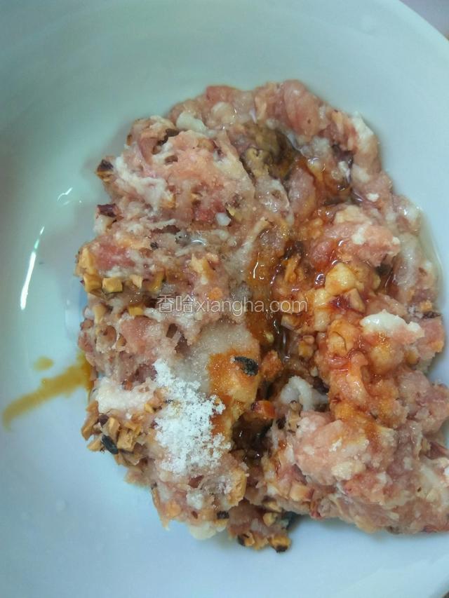 将剁好的猪肉和香菇，鱿鱼放在碗里拌匀，加油，适量盐和酱油腌一下备用。(比炒菜稍微咸，因为待会要下水焖，怕被水冲太淡了)