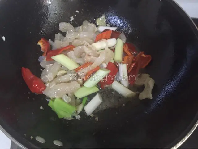 炒至红椒快熟时放入盐和鸡粉调味，然后放入葱段
