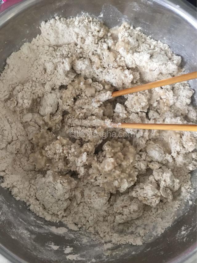 烧开水倒入盛有莜面的盆中，用筷子搅拌。