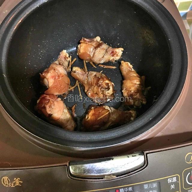 电饭煲预热，将小鸡腿和腌料一起放入锅中，按煮饭键