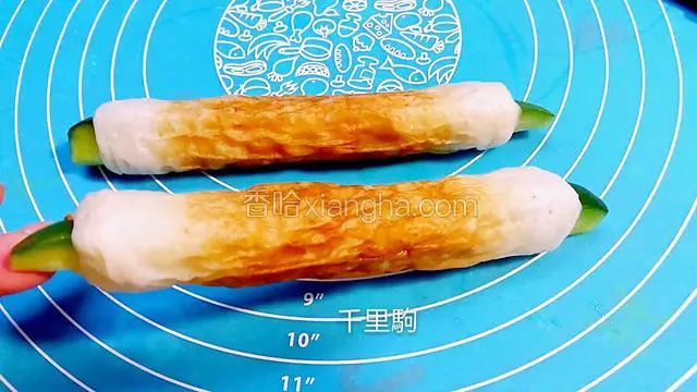 竹轮卷蒸熟，里面穿入一条切开的小青瓜条