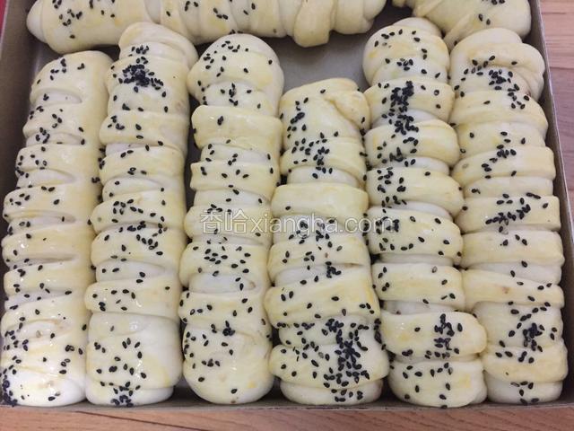 全部做好后放入烤箱，底部放盆热水，开始二次发酵，发酵好的面团表面刷蛋液，洒芝麻