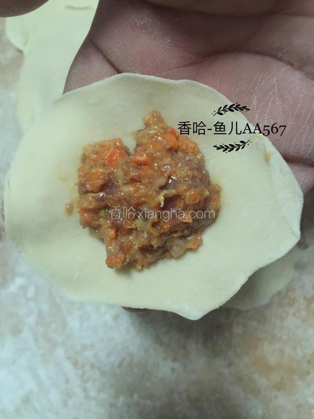 取一个面皮放上肉馅。