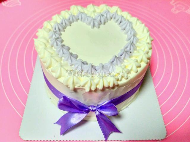 用樱花嘴裱二圈花。紫色我是用红加蓝的色素调的。周边包一圈慕斯围边，系上丝带。