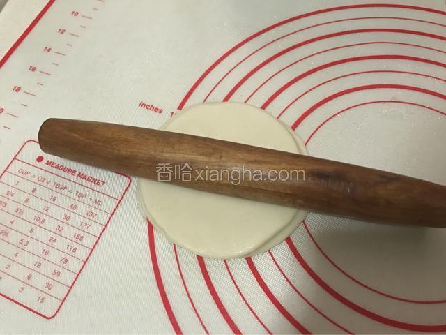 用用擀杖在中间使劲压一下，这样擀的时候就不会滑动了。