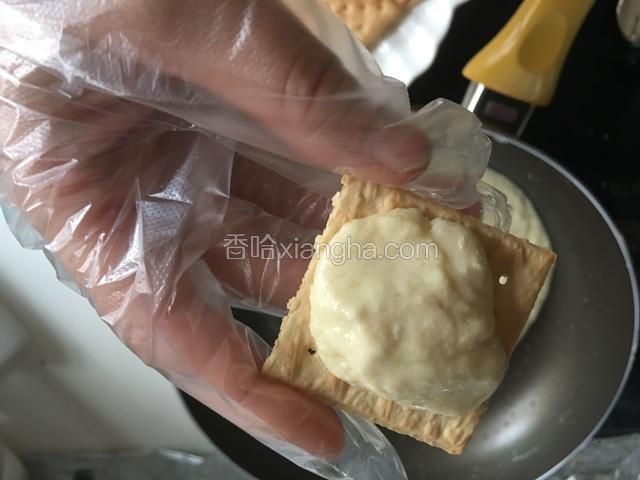 戴上一次性手套取适量牛扎糖放在梳打饼上