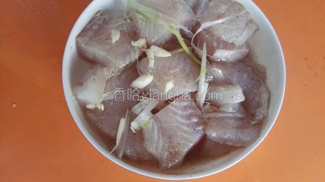 切好的龙利鱼块装盘，放入蒜、香葱、料酒、盐腌制15分钟。