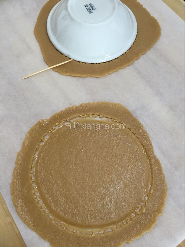 放在油纸上擀成薄片 倒扣一个盘子 用牙签沿着盘子边缘划去多余的面皮
