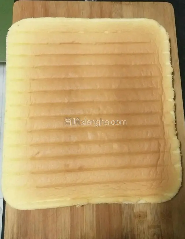 烤好出炉后倒扣在晾网上，趁热撕掉油布，晾凉后，反扣在干净的案板上，切点蛋糕的边。