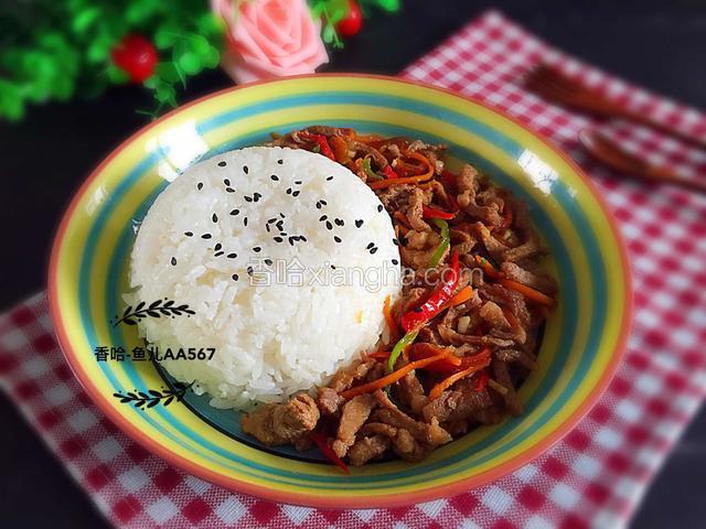 米饭倒扣在盘中，放入炒熟的彩椒胡萝卜肉丝，可以撒些黑芝麻在米饭上。。