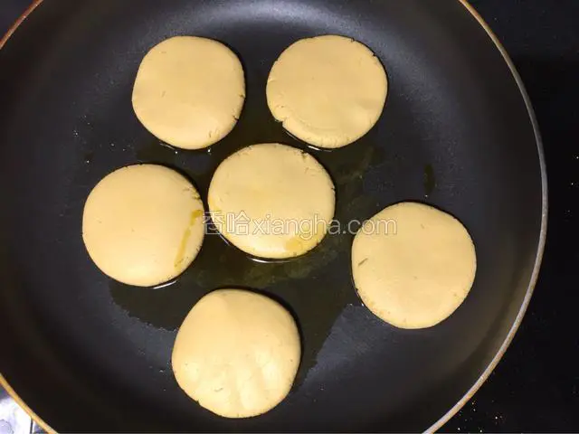 平底锅倒入适量的食用油，将南瓜饼放入锅中，中小火煎