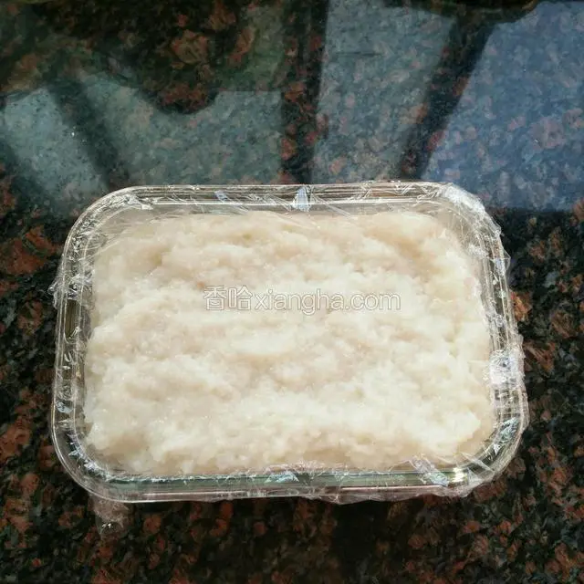 准备一个玻璃盒，在盒子里铺一层保鲜膜，米饭稍冷却，用玻璃盒装好，用擀面杖把糯米饭压烂一些，再压实