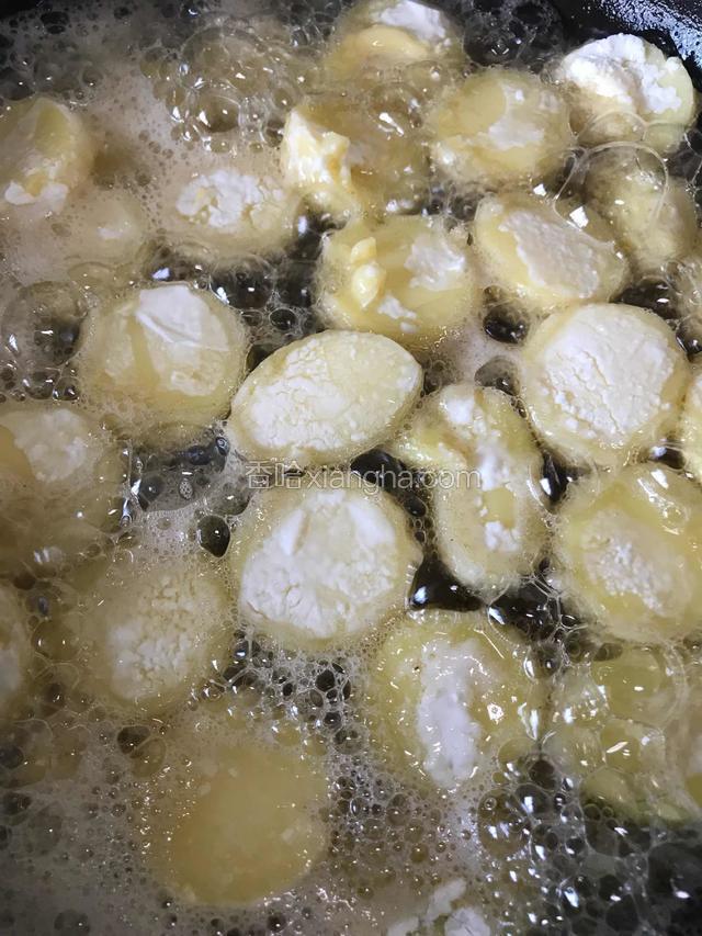 锅内烧热油，六成热油下入豆腐片炸