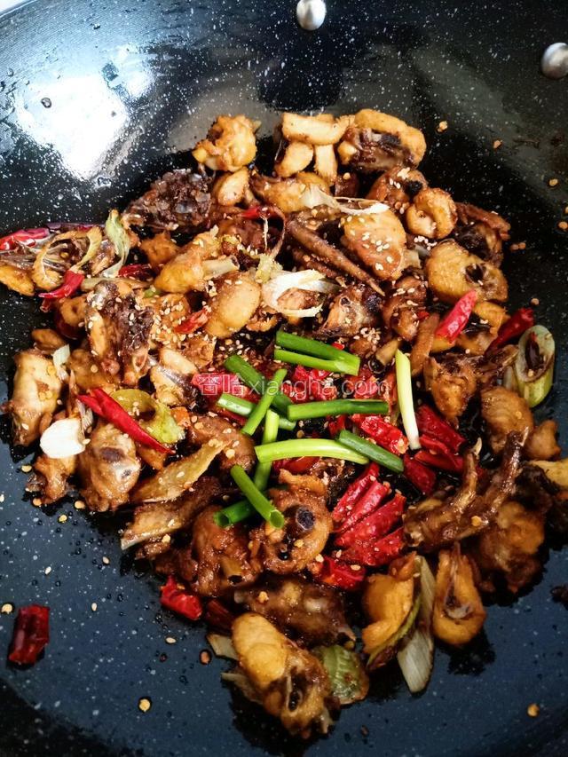 倒入炸好的鸡块，生抽，耗油，白糖，白芝麻，葱段鸡精，翻炒几下