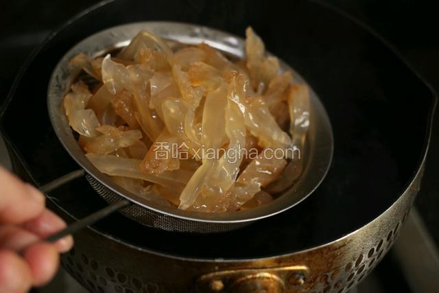 把切丝的海蜇放入还没开的热水中，关火，汆烫几秒，迅速捞出。