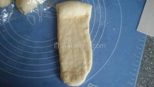 用擀面杖擀长条，宽约6厘米，长约30厘米，从一边卷起