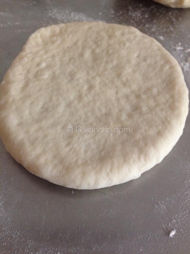 用擀面杖擀成1厘米厚的圆饼，放入烤盘。