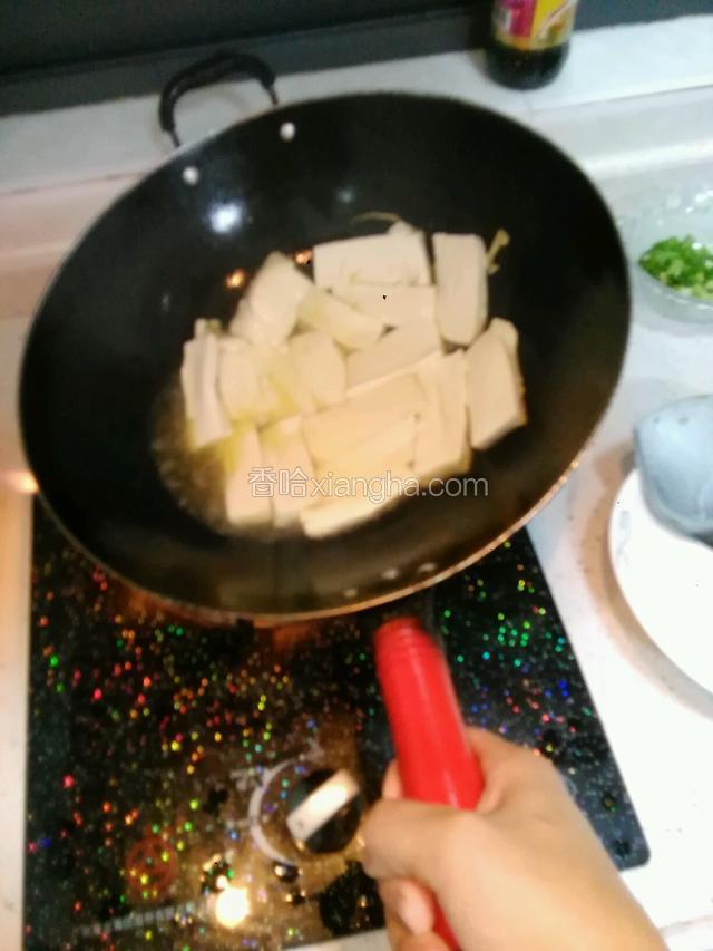 全部放入后往豆腐面均匀的撒点点盐，提示（不要用锅铲去动豆腐，不然会很容易烂，用水把锅把轻轻的挪动，尽量用锅里的油均匀煎到每块豆腐微微黄）