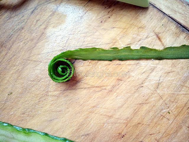 取片好的黄瓜长条一条(一般从皮开始,如果不喜欢吃皮就不用了),从一端向另一端卷起,尽量卷紧,我因为要拍照,不得不松开手