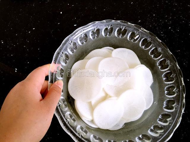 腌制20分钟，白萝卜片变软，会渗出汁液，倒掉。在放入剩余的盐和糖腌制20分钟，倒掉渗出的液体。