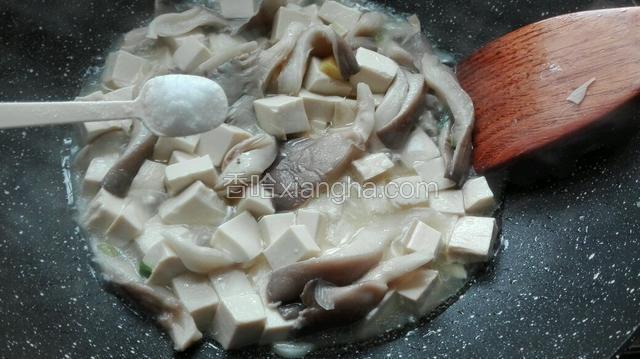 当豆腐煮约五分钟，放入适量盐、十三味香，均匀搅拌。