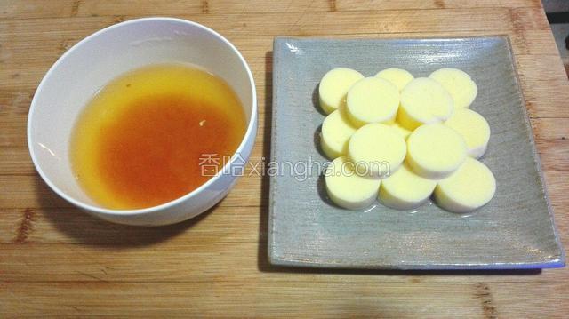 将玉子豆腐切1厘米薄片，橙子，柠檬榨汁，加1勺糖，2勺水将适量橙子皮切小丁放入碗中