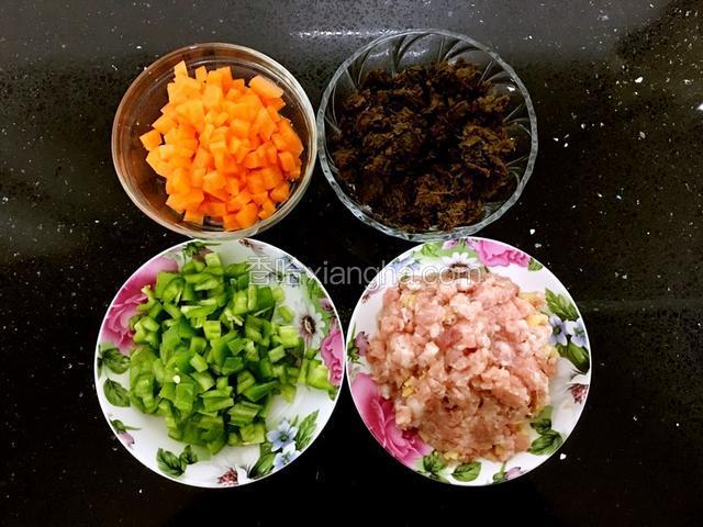 胡萝卜和尖椒切丁。葱姜丝末，放入肉馅中拌均。在用料酒腌制10分钟左右。