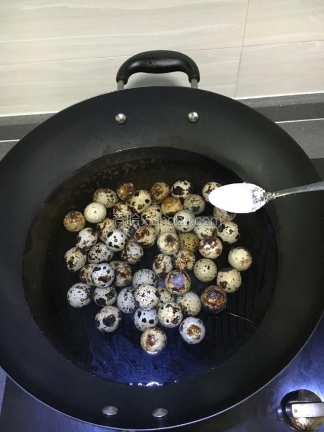 锅中冷水放入鹌鹑蛋，加一勺盐煮十分钟后，捞出冲凉水，剥壳备用。