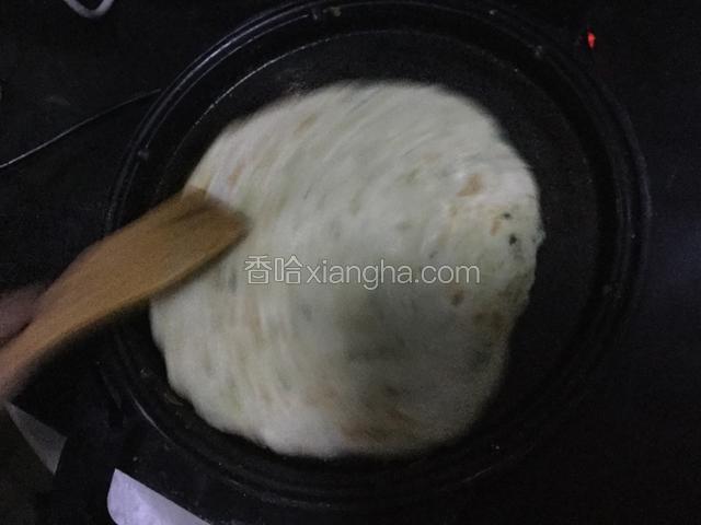 焖制过程中，用木铲将饼边旋转，边将面饼往松里推，这样做可以使饼酥松。
