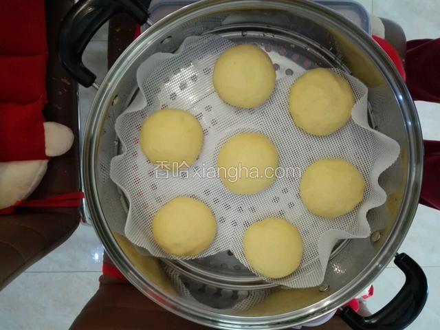 把留好馒头发酵空间的蒸笼，摆进已经煮沸的蒸锅里。