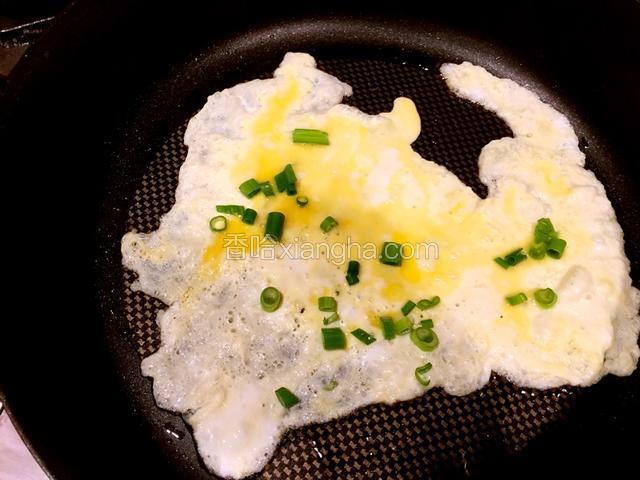 热锅，倒入适量的油，不要太多，同时将鸡蛋打成蛋液，倒入锅中，转一下锅，使鸡蛋铺均匀，散葱花