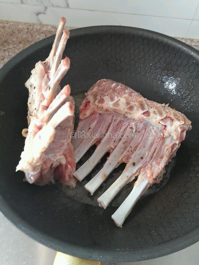 油下锅，然后放羊排煎，每面煎六分钟左右，尽量每一面都煎到。