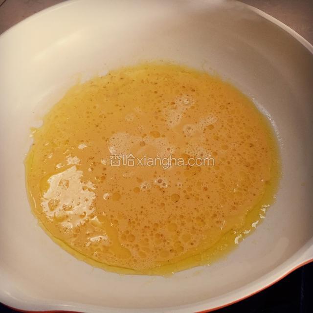 蛋糊均匀平铺锅底，小火至表面起泡，放入切好的草莓片。