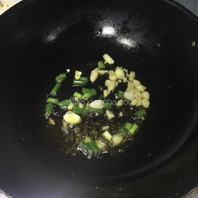 揪完面片快煮熟的时候 炒锅放油待5成热放入切好的蒜粒 还有小葱段煸香