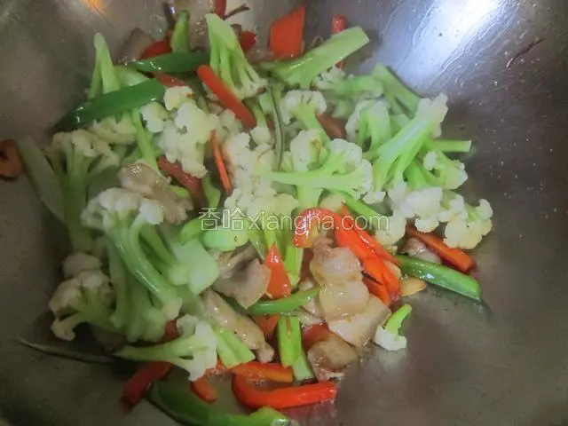 接着加入焯好的菜花，炒匀，因为菜花是熟的不用炒太久，并且炒久了破坏蔬菜的营养成份