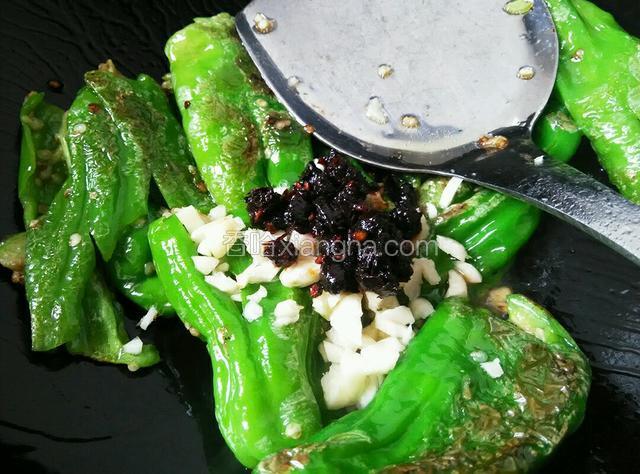 煎好后放入大蒜和老干妈豆豉，翻炒均匀