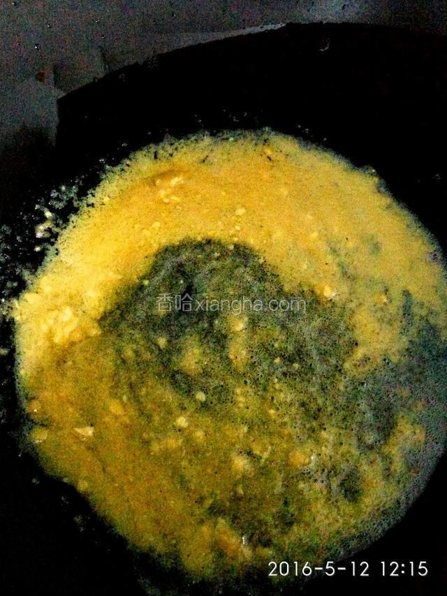 炒锅中放入搅拌好的咸鸭蛋黄，小火不停的翻炒，见蛋黄液全变成金黄，香味飘出并起泡泡时倒入揉好的各色小面球翻炒。