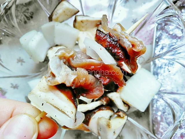 将腌制好的牛肉、洋葱、香菇交错均匀的串到竹签上。