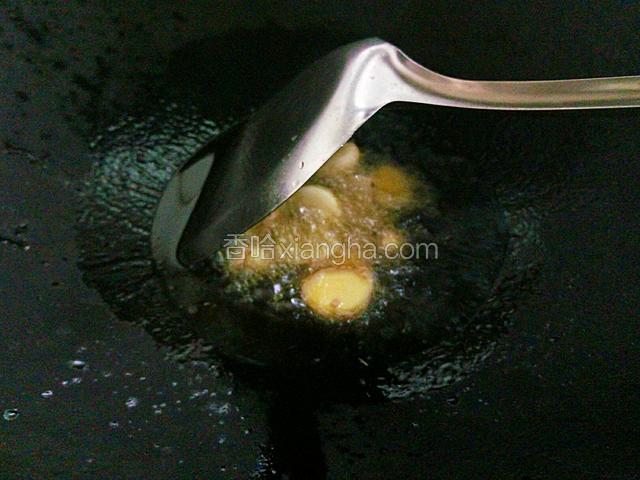 锅中倒油烧热，下姜蒜翻炒片刻。