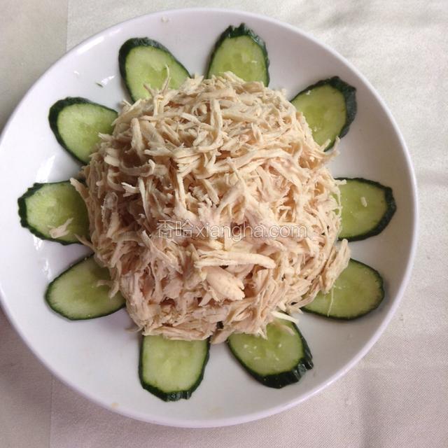 底部用黄瓜片围一圈，中间放上敲松的鸡肉丝。
