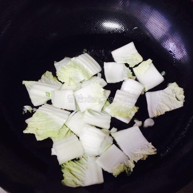 把白菜帮子倒进去翻炒一分钟