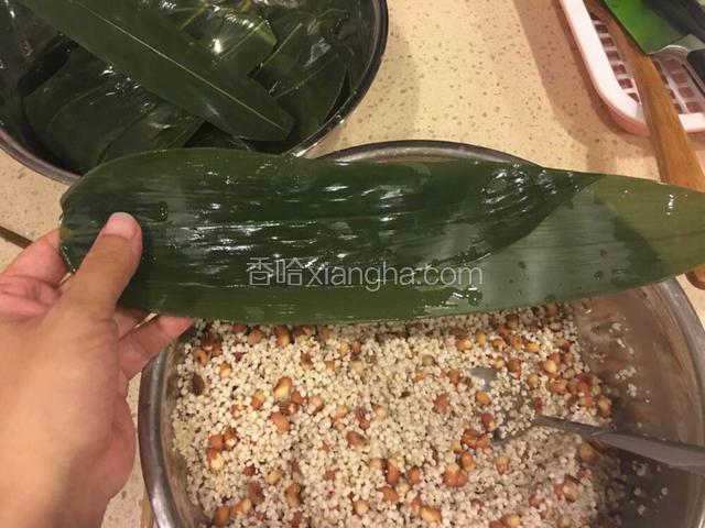 取两片粽叶，交错搭在一起。（粽子叶大的话用一片就可以）